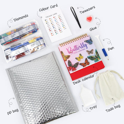 Collection of stationery items including a butterfly-themed desk calendar, bubble wrap, and other office supplies on a white background.