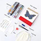 Set of diamond painting tools including a pen, tweezers, color card, tray, glue, and a bag on a white background.